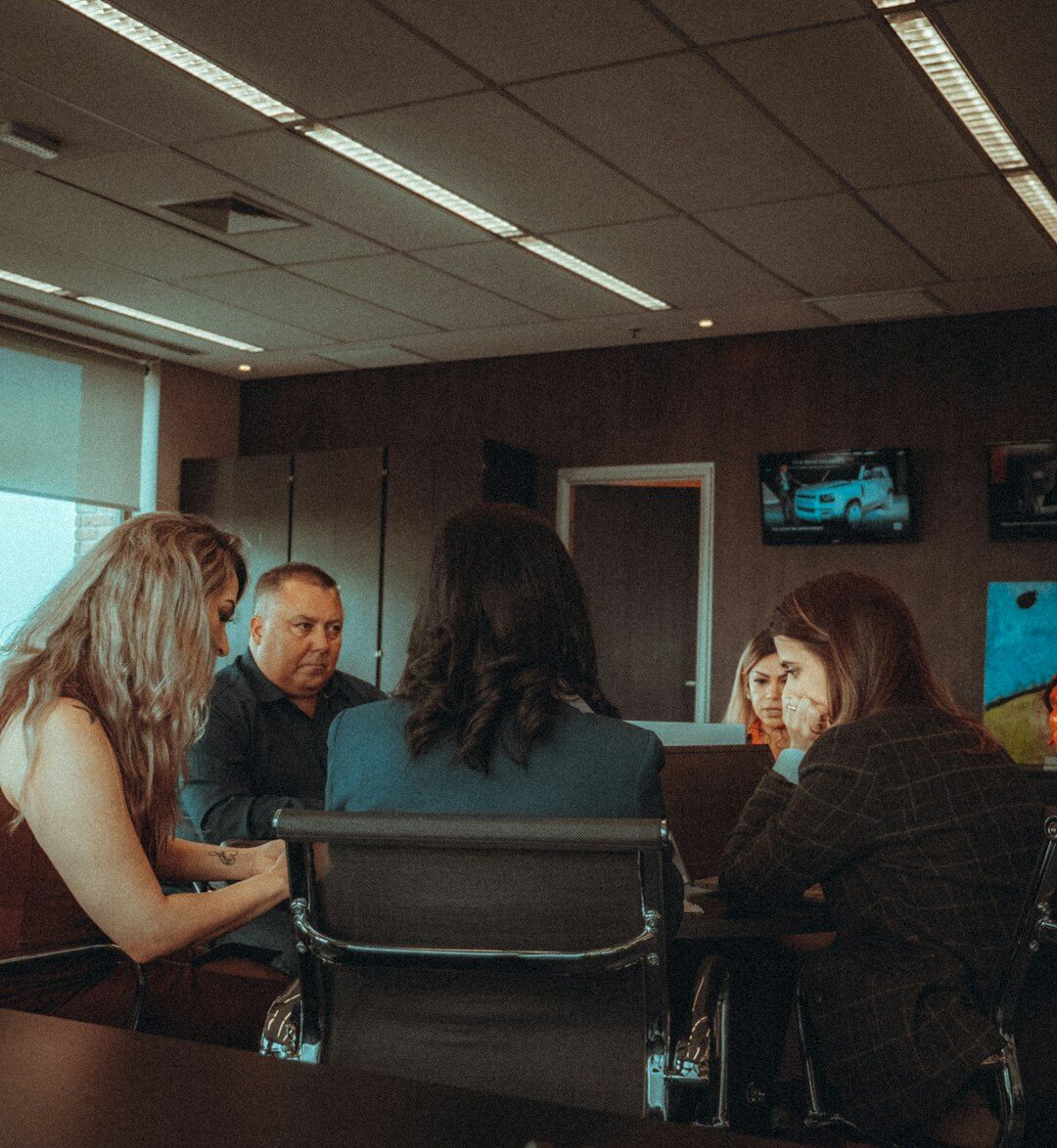 Two colleagues discussing an entertainment story in an office