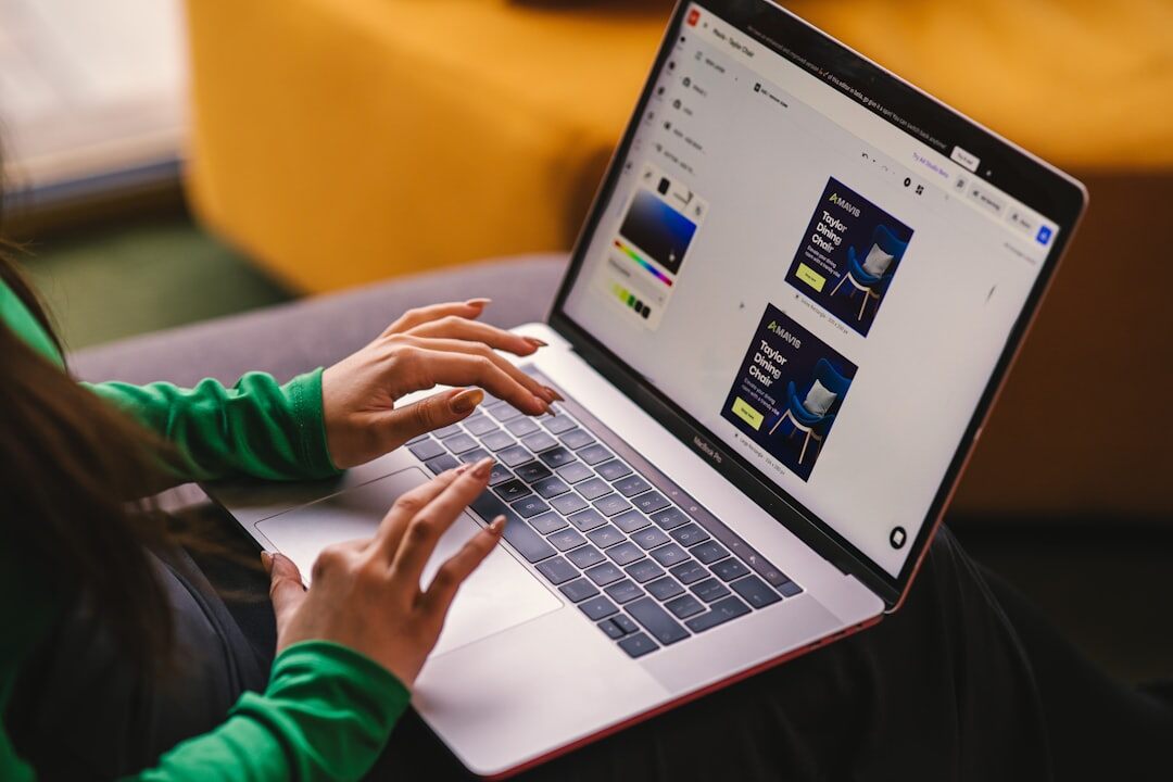 Editor fact-checking a story on a laptop with reference documents