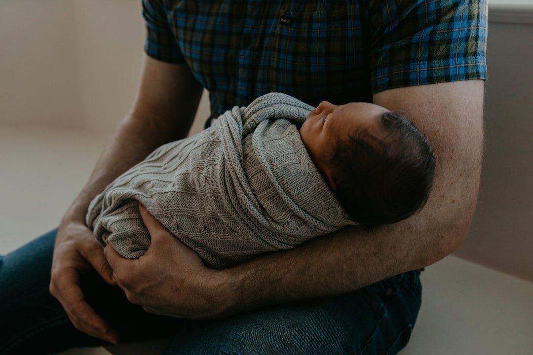 football player holding newborn